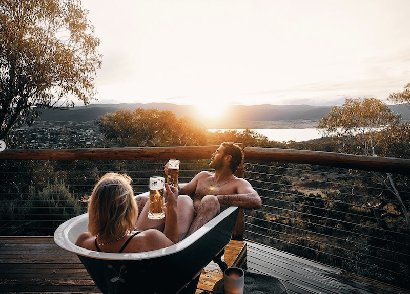 Snowy Mountains — outdoor hot tub at sunset